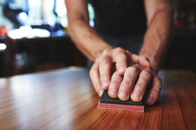 person sanding polyurethane