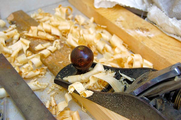 carpenter plane and wood shavings