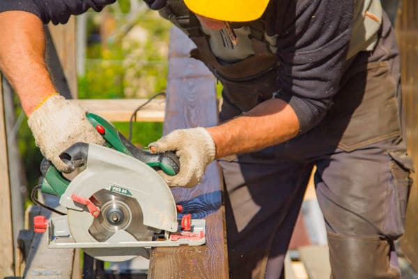 craftsman cutting wood with a circular saw