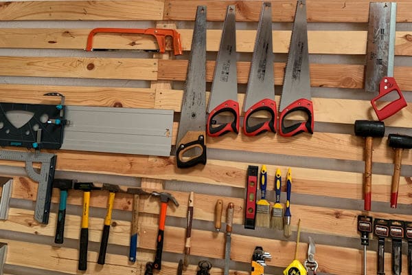 a collection of saws and other tools in a woodworking shop