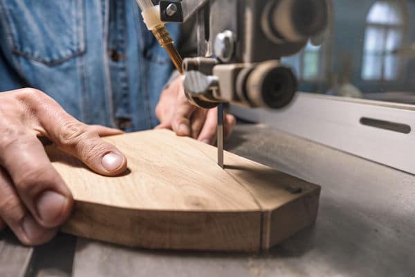 carpenter cutting wood with a bandsaw