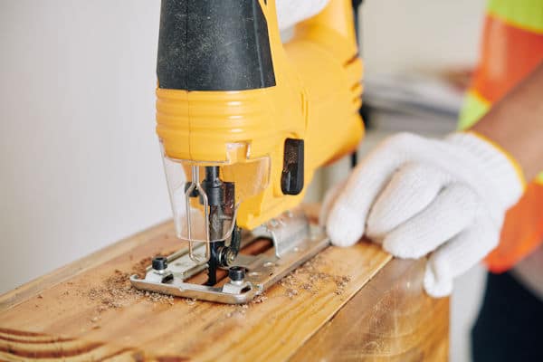 carpenter cutting with a jigsaw